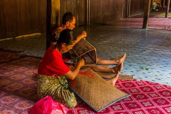 Weaving rattan mats and baskets in the longhouse. Pic: Matyas Rehak